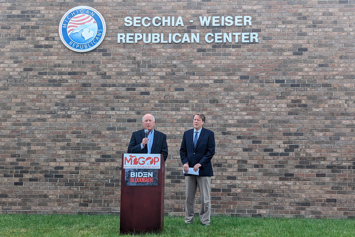 Michigan Republican Party Chair Pete Hoekstra and Senate Republican Leader Aric Nesbitt, standing outside the party's headquarters