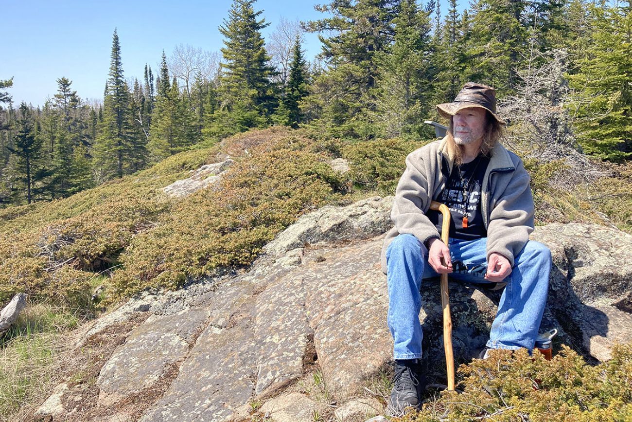 a man sitting on a rock