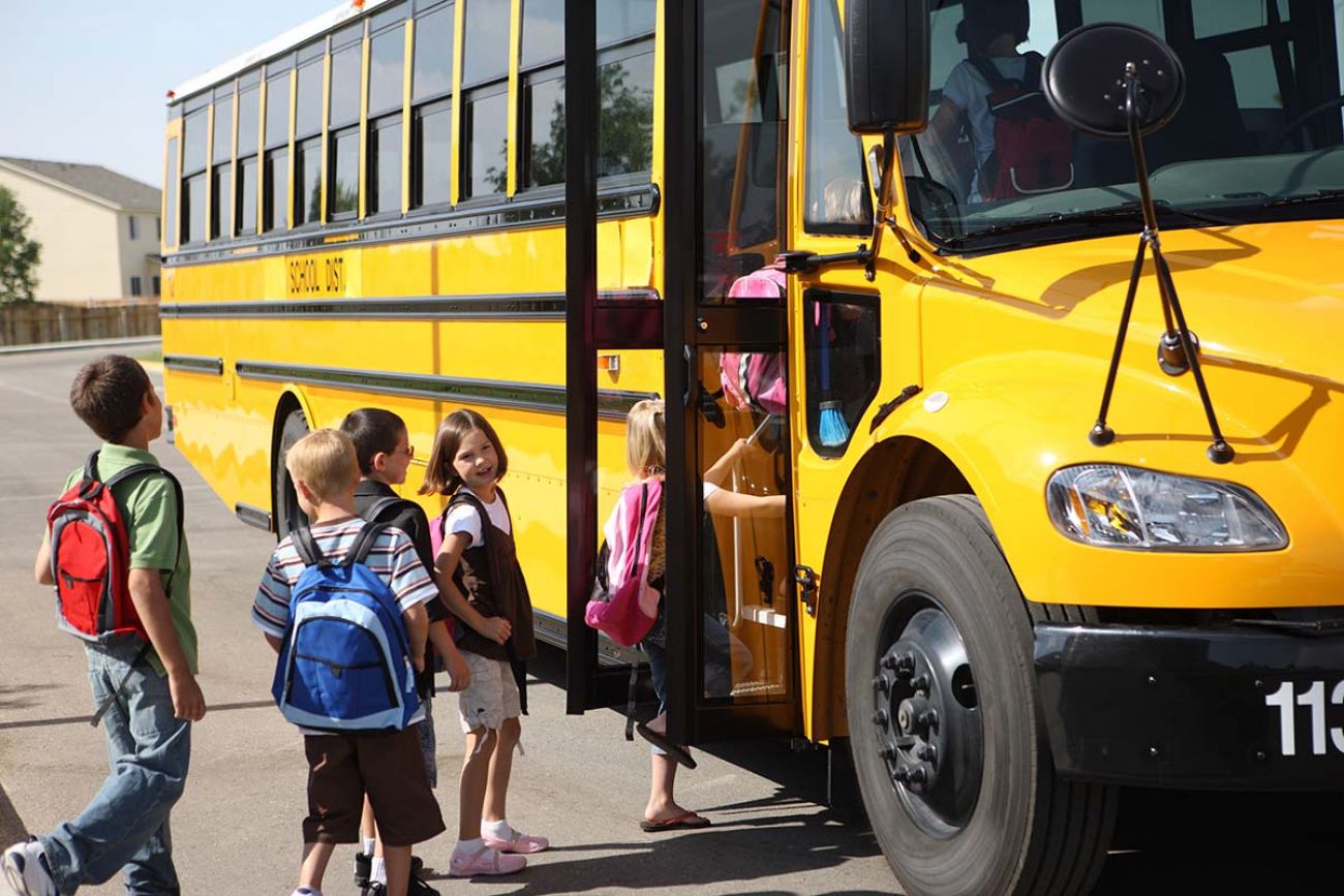 kids getting on school bus