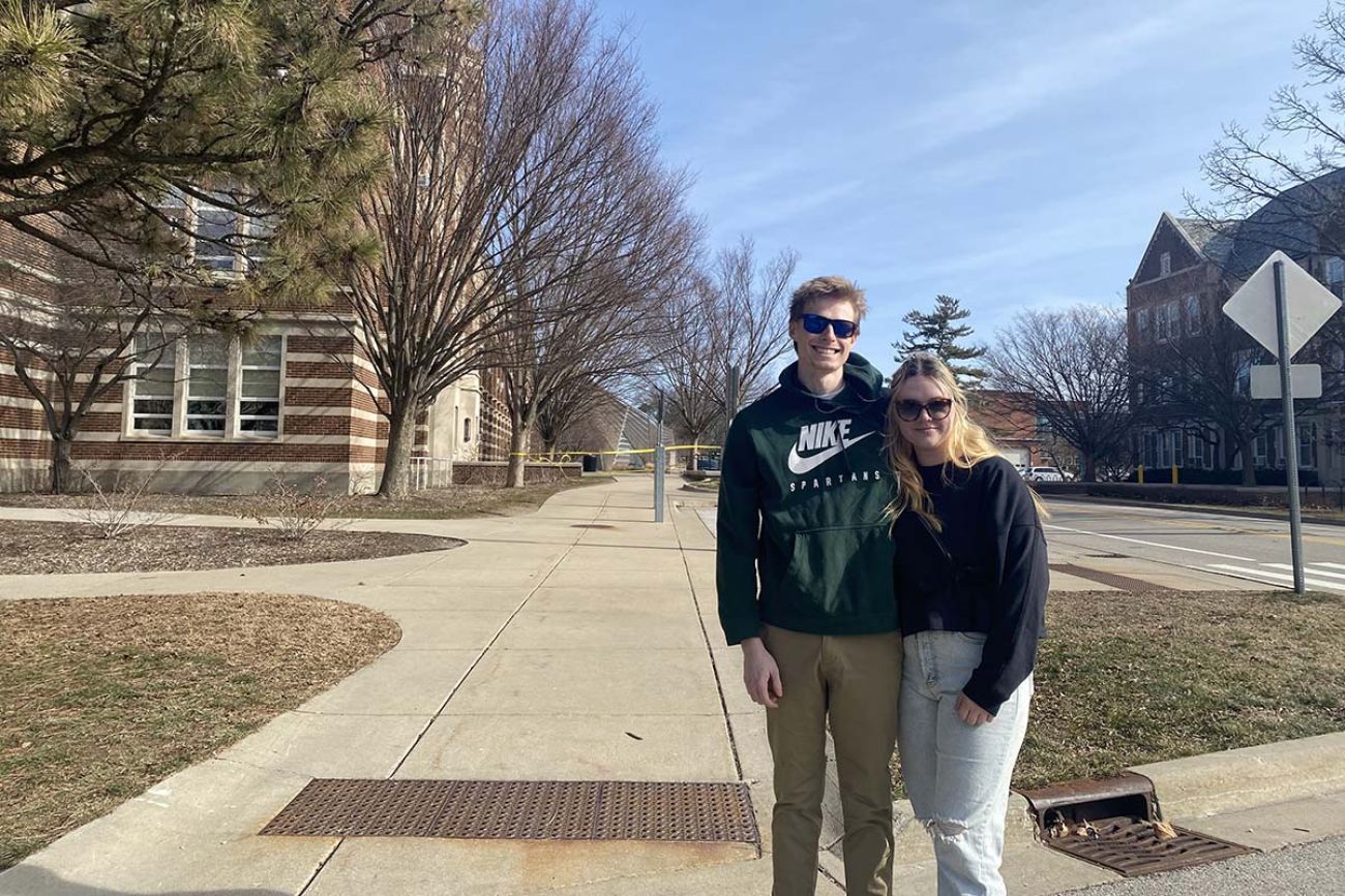 two people posing outside