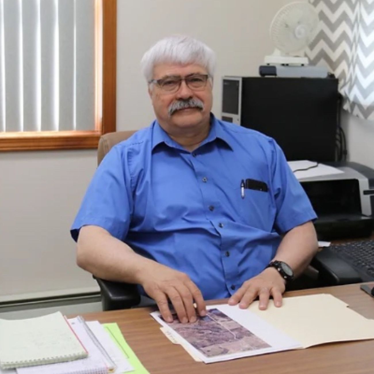 Man sits at desk.