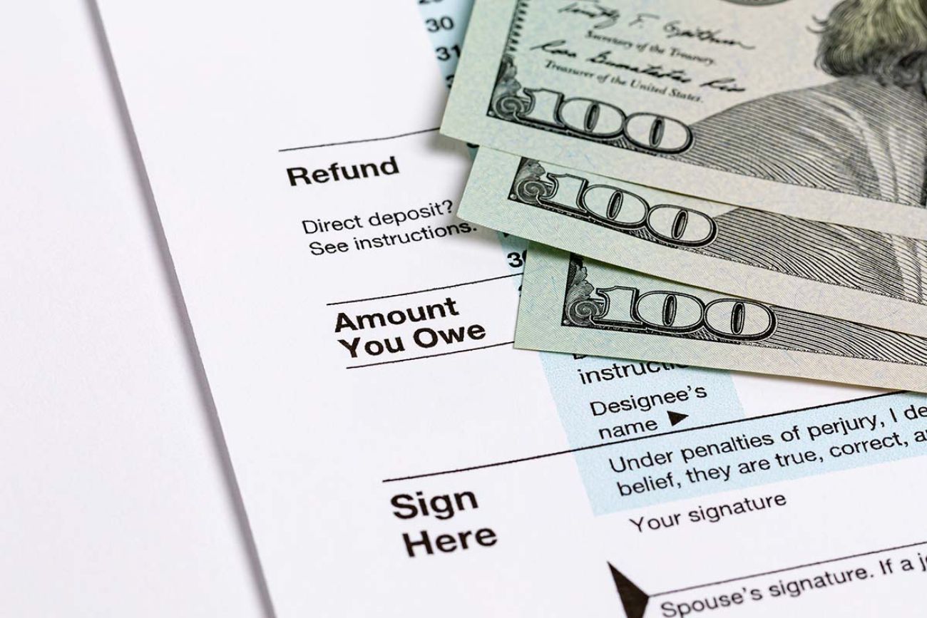 1040 individual income tax return form and money.