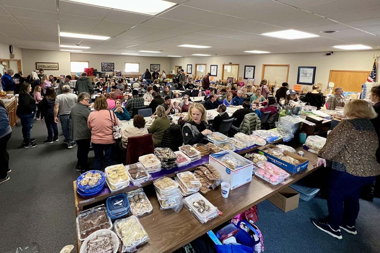 a bunch of people in a room with food