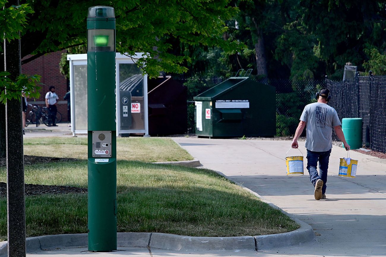 a phone outside; person walking pass