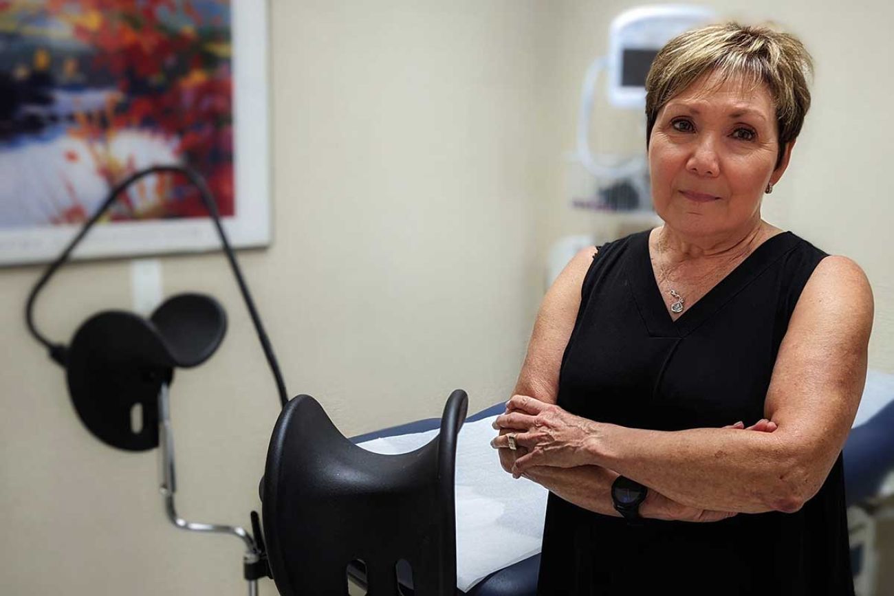 Renee Chelian standing in a doctor's office 