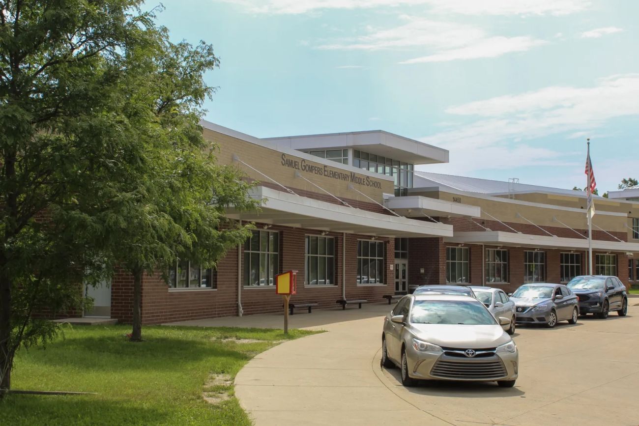 cars lined up in front of school