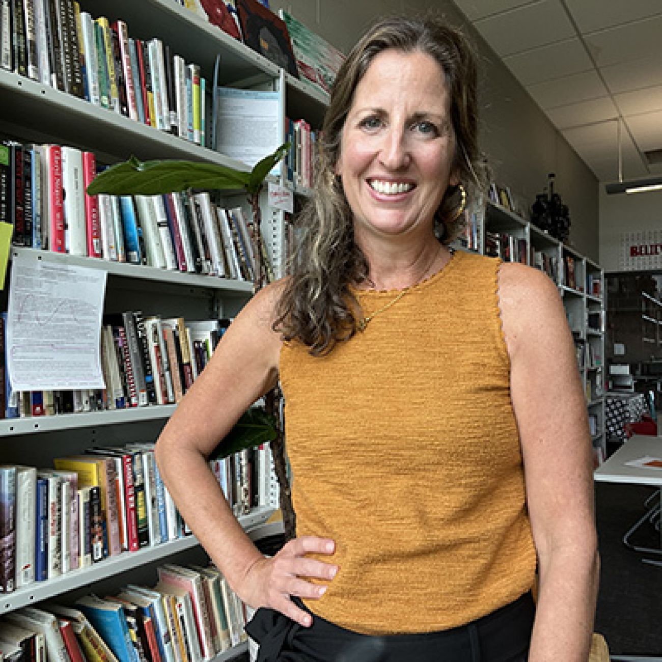 Janelle Miles in front of book shelves