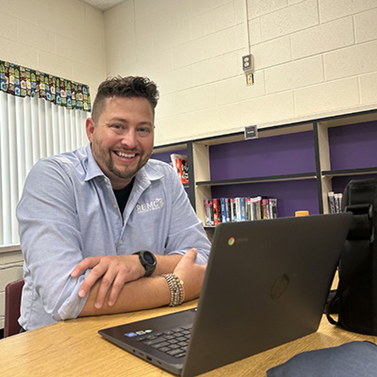 Mark Lyons in front of a laptop in a classroom