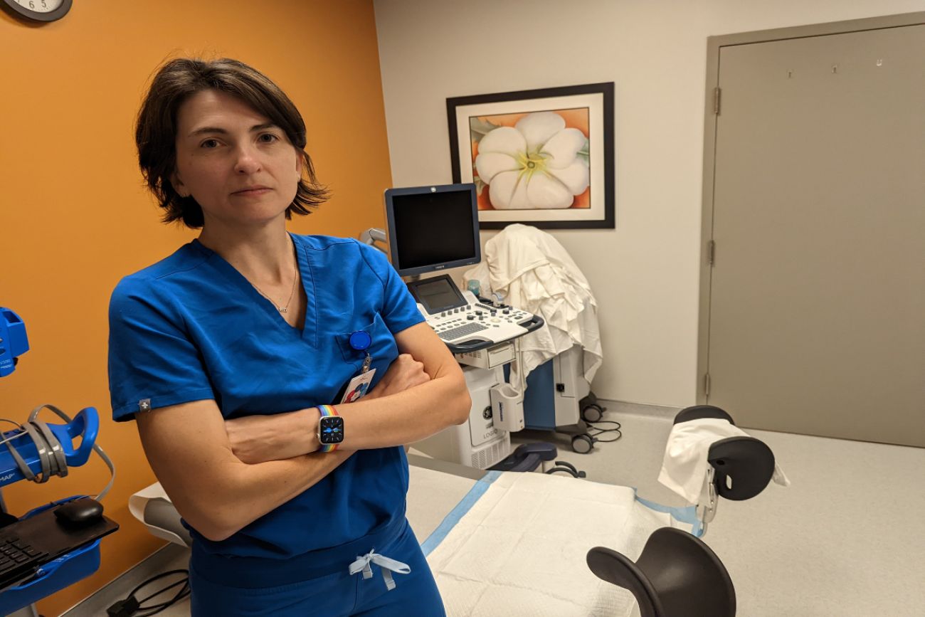 Doctor stands in front of medical equipment