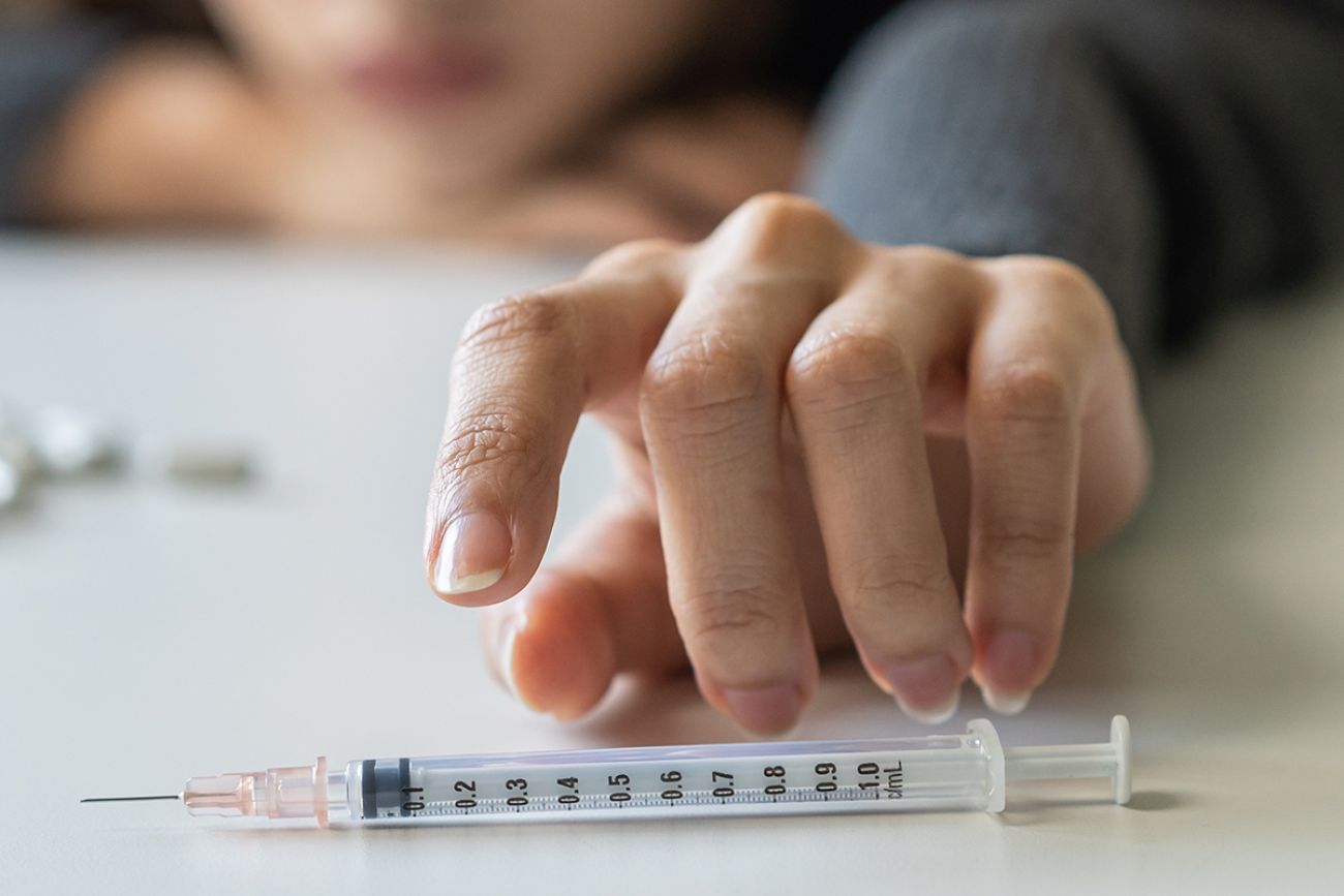 girl hand reaching for syringe,