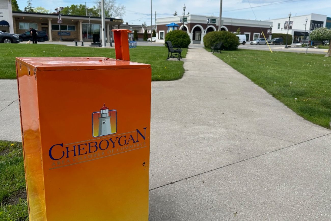 An orange newspaper box outside