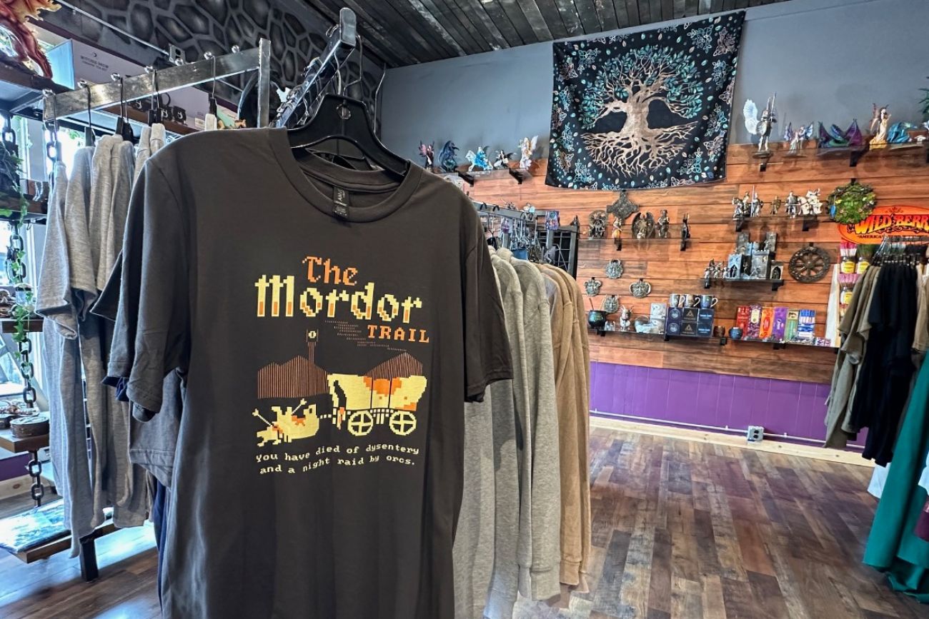 Inside a store, a tshirt is hung up that says the "Mordor Trail"