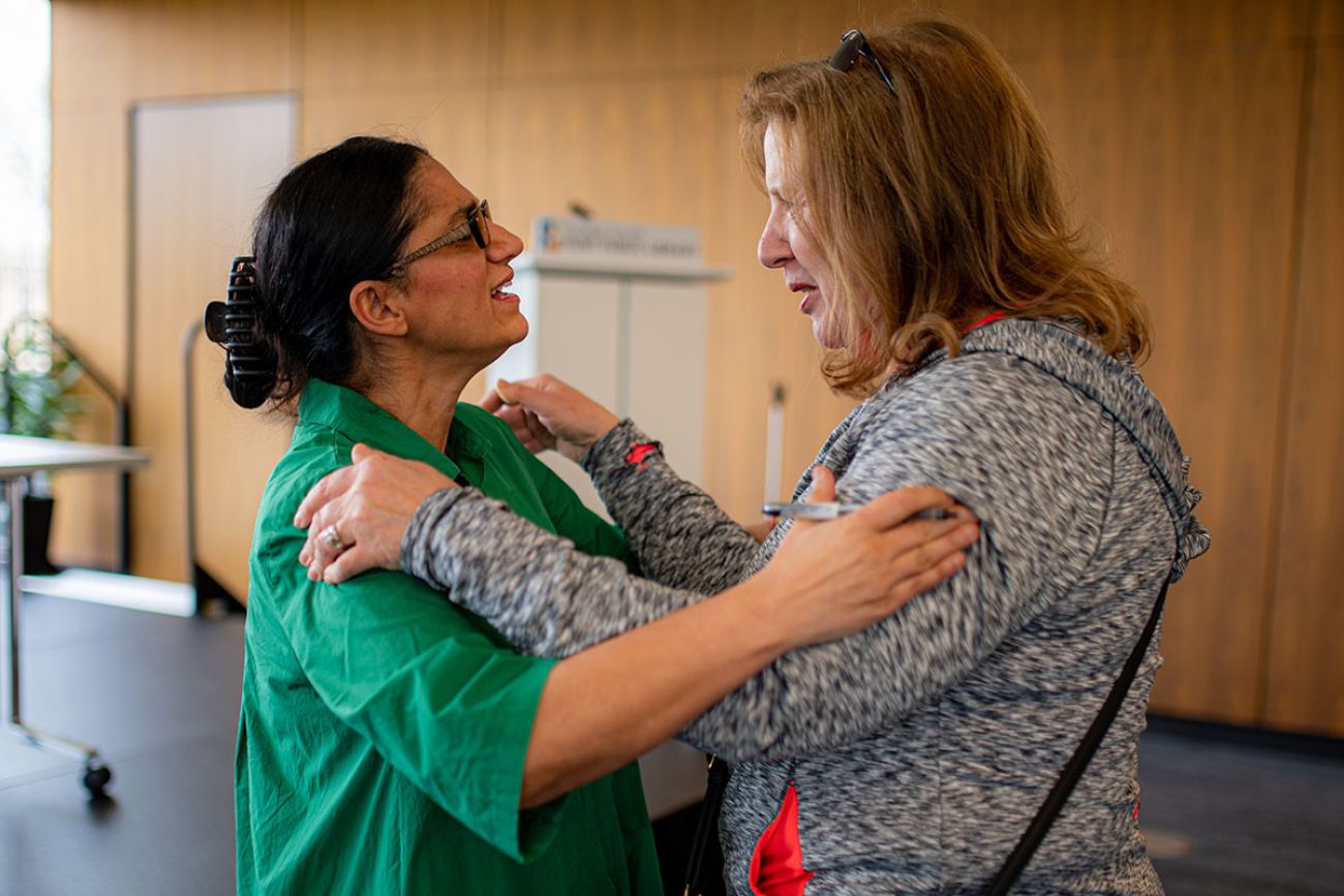 Dr. Mona Hanna-Attisha hugging another woman