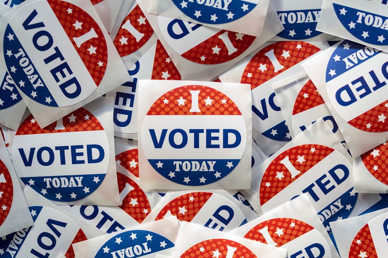 Top view of pile of Voting stickers. The stickers are red, white and blue