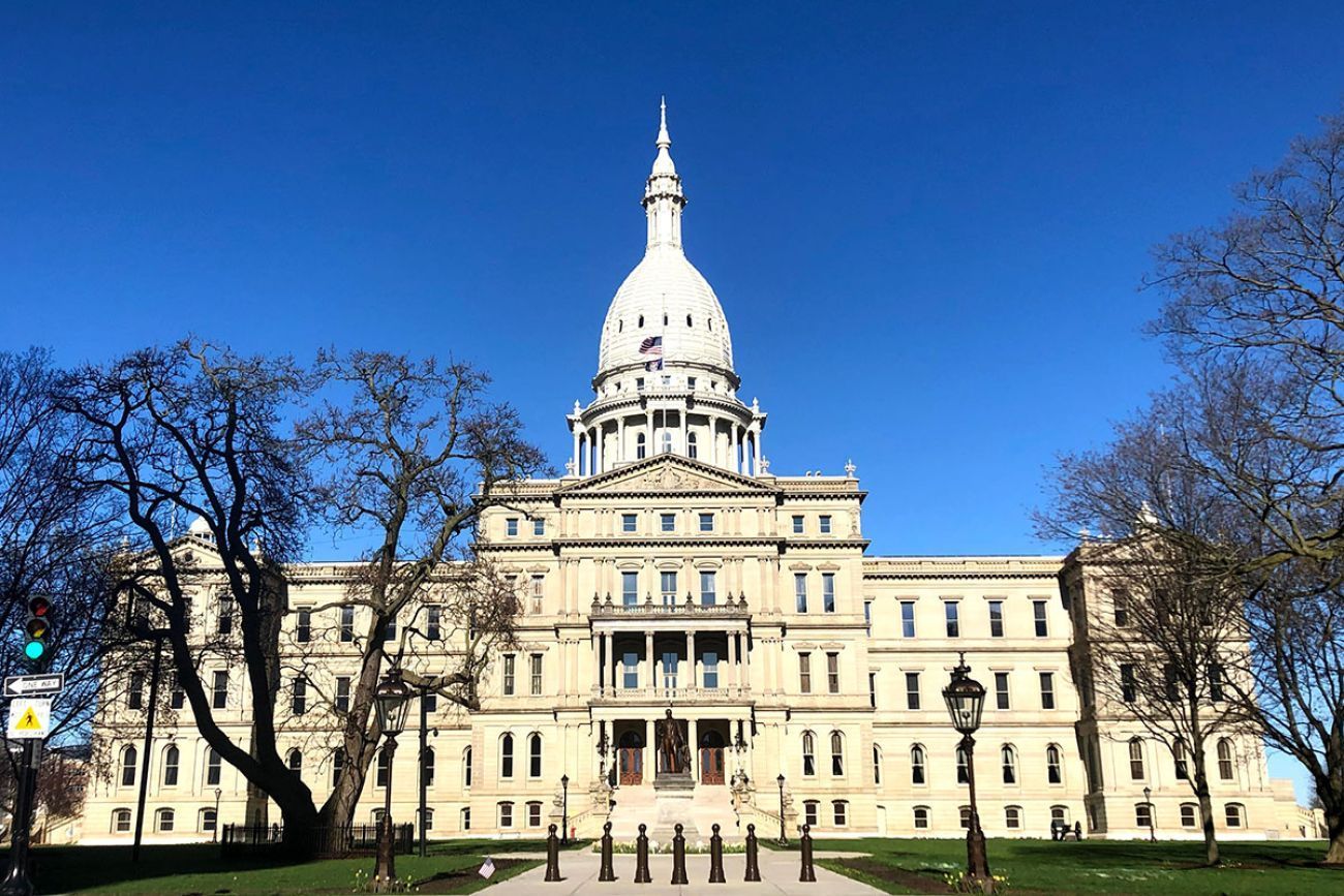 The outside of the Michigan capitol building on a sunny day