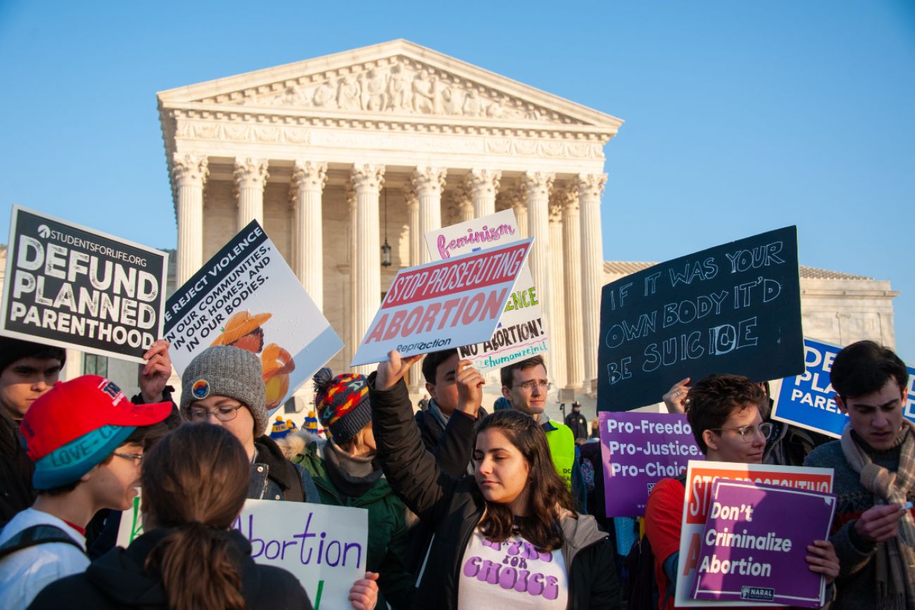 Protestors outside of the Supreme Court with pro and anti abortion signs