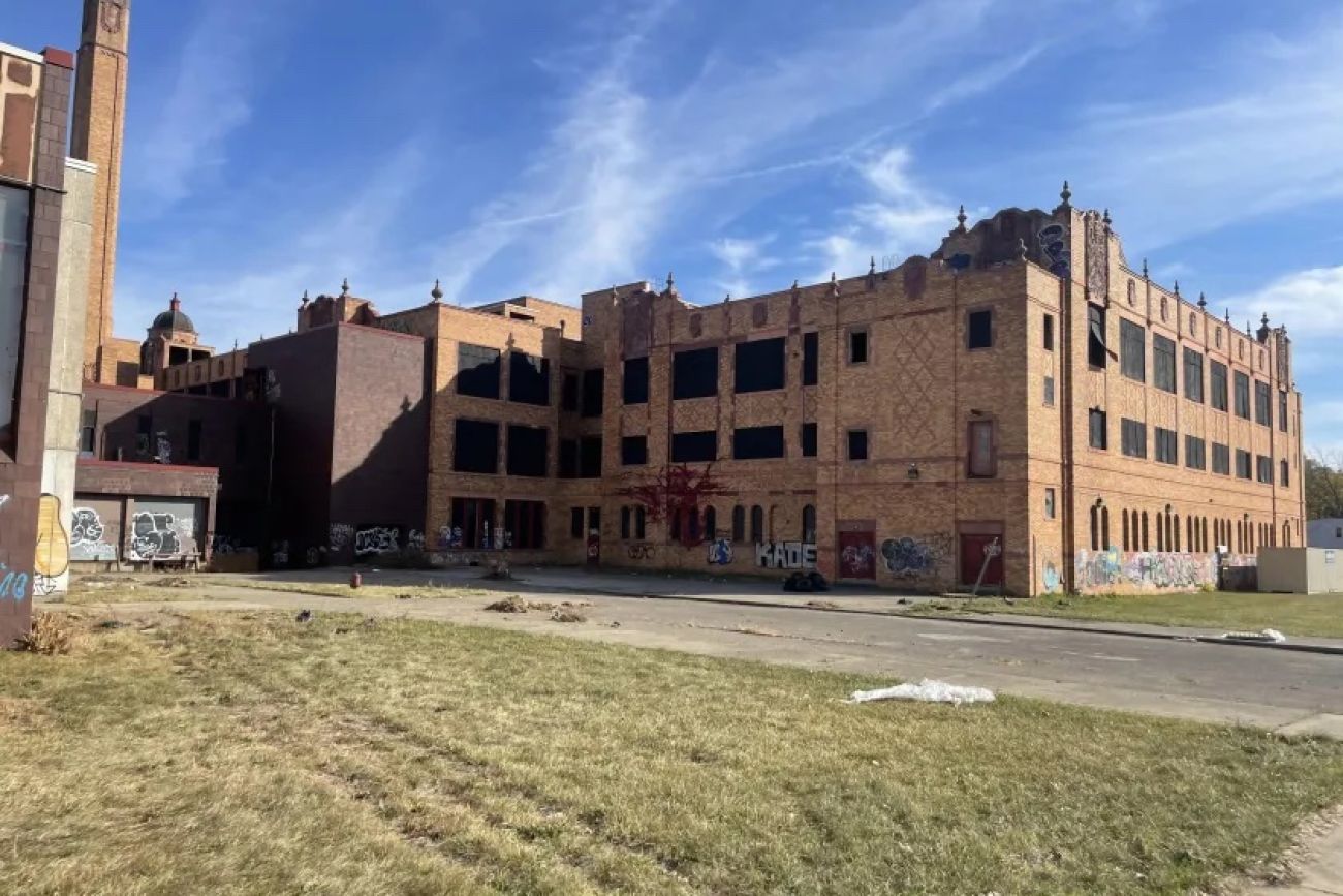 vacant Cooley High School. The building has graffiti on the side