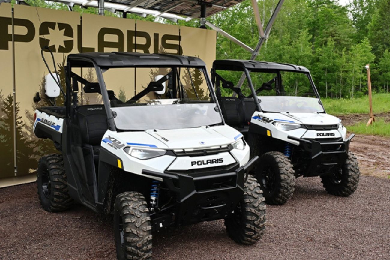 Two white, electric off-road vehicles 