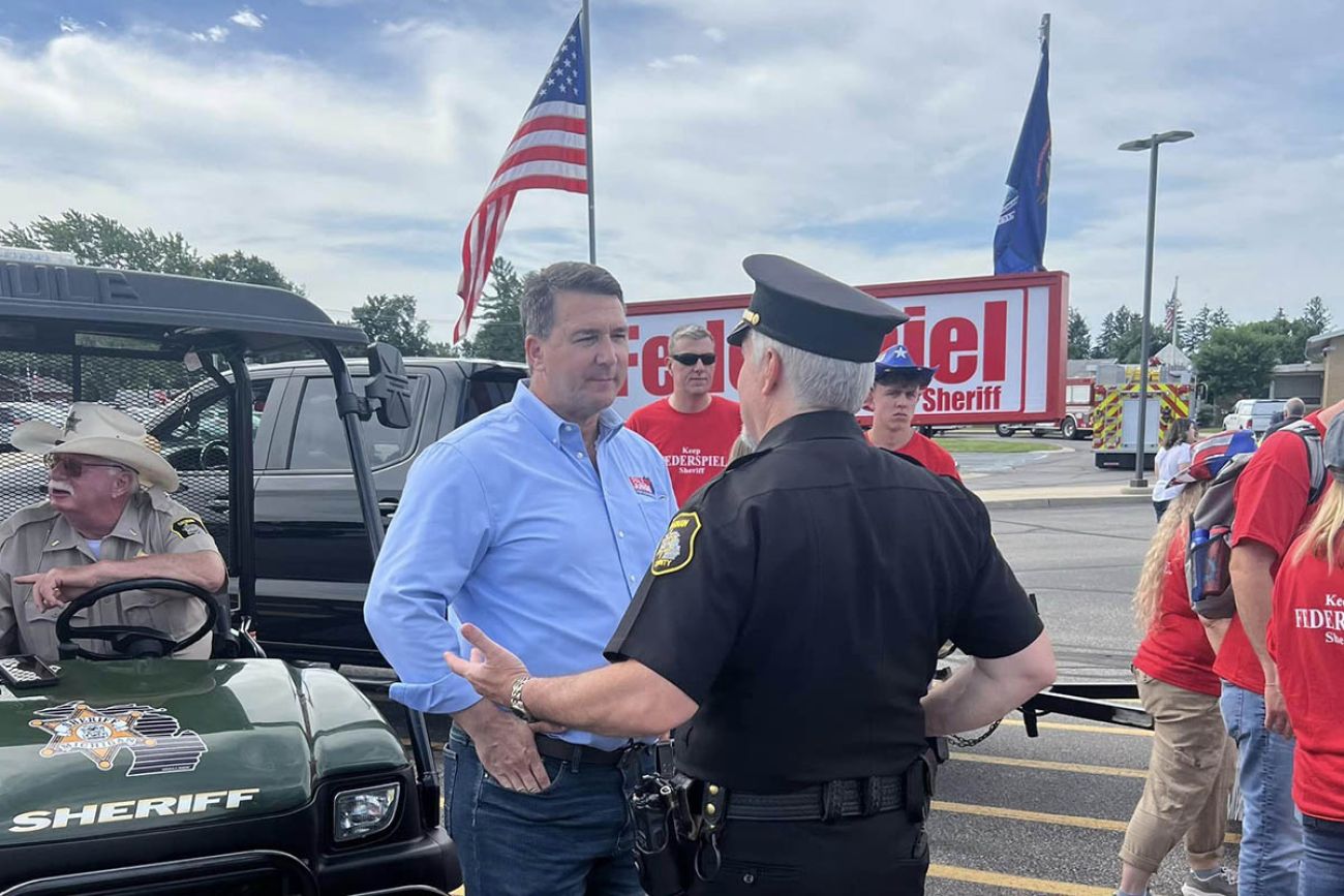 Paul Junge is outside, speaking to a supporter