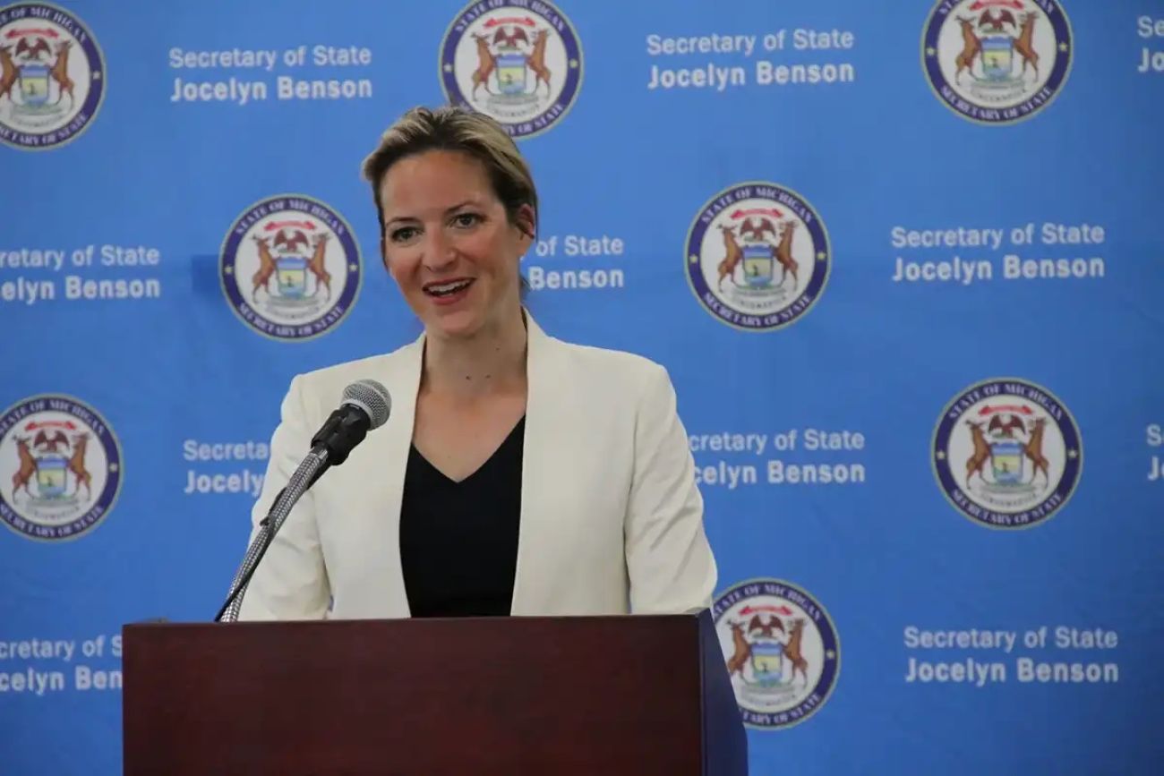 Michigan Secretary of State Jocelyn Benson speaking into a microphone