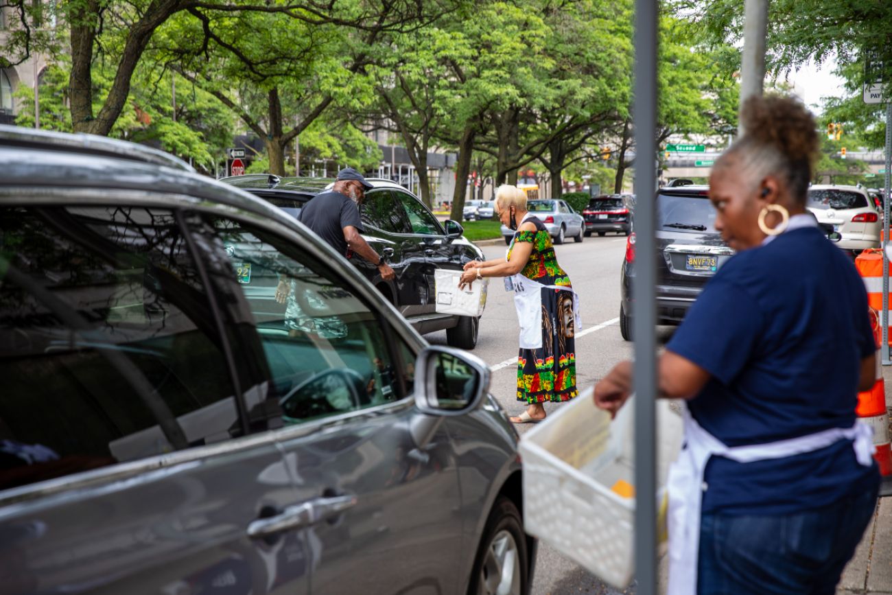 People picking up ballots from people in their cars