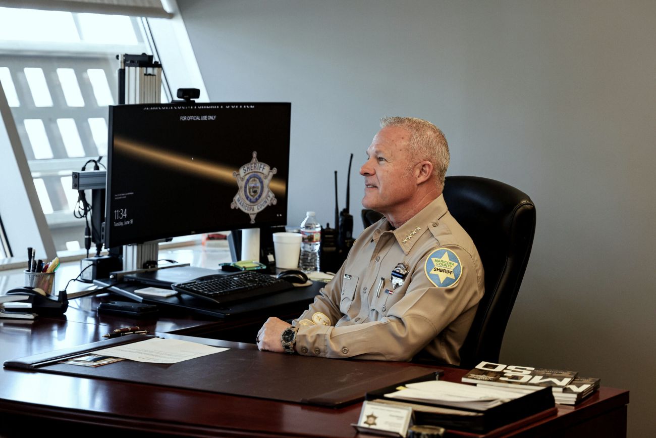 Maricopa County Sheriff Russ Skinner sitting at his desk