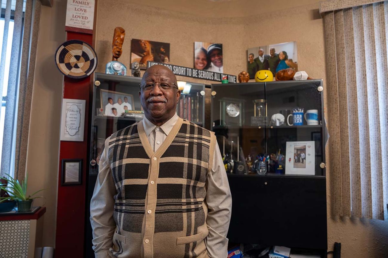 Dwight Vaughter poses for a picture in his office