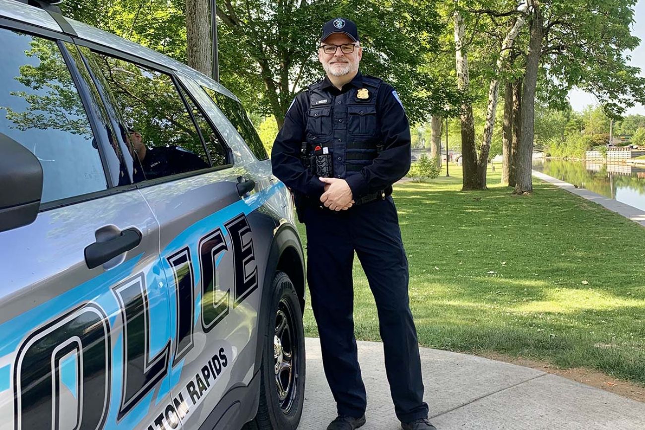 Chief Larry Joe Weeks poses next to an Eaton Rapids police car