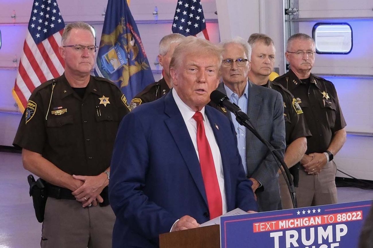 Donald Trump speaks into a microphone at an event in Michigan