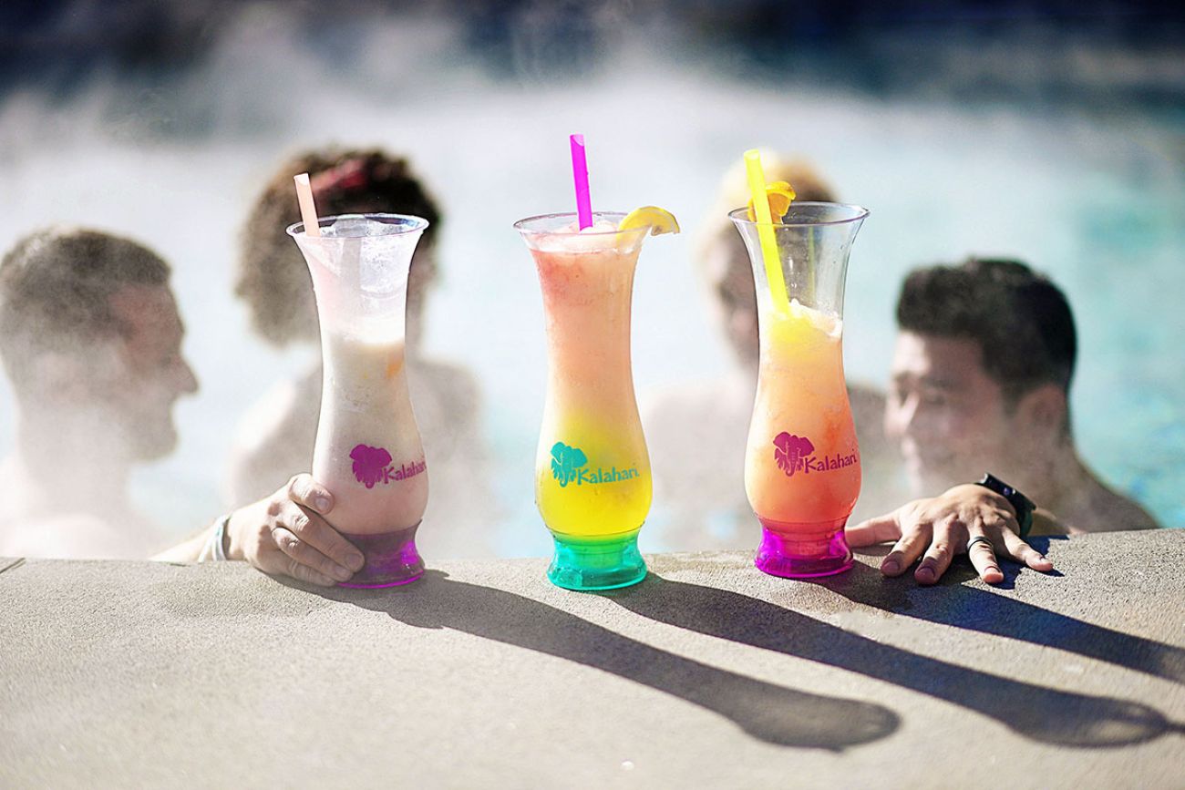 Cocktails in Kalahari-themed glasses on the side of a pool