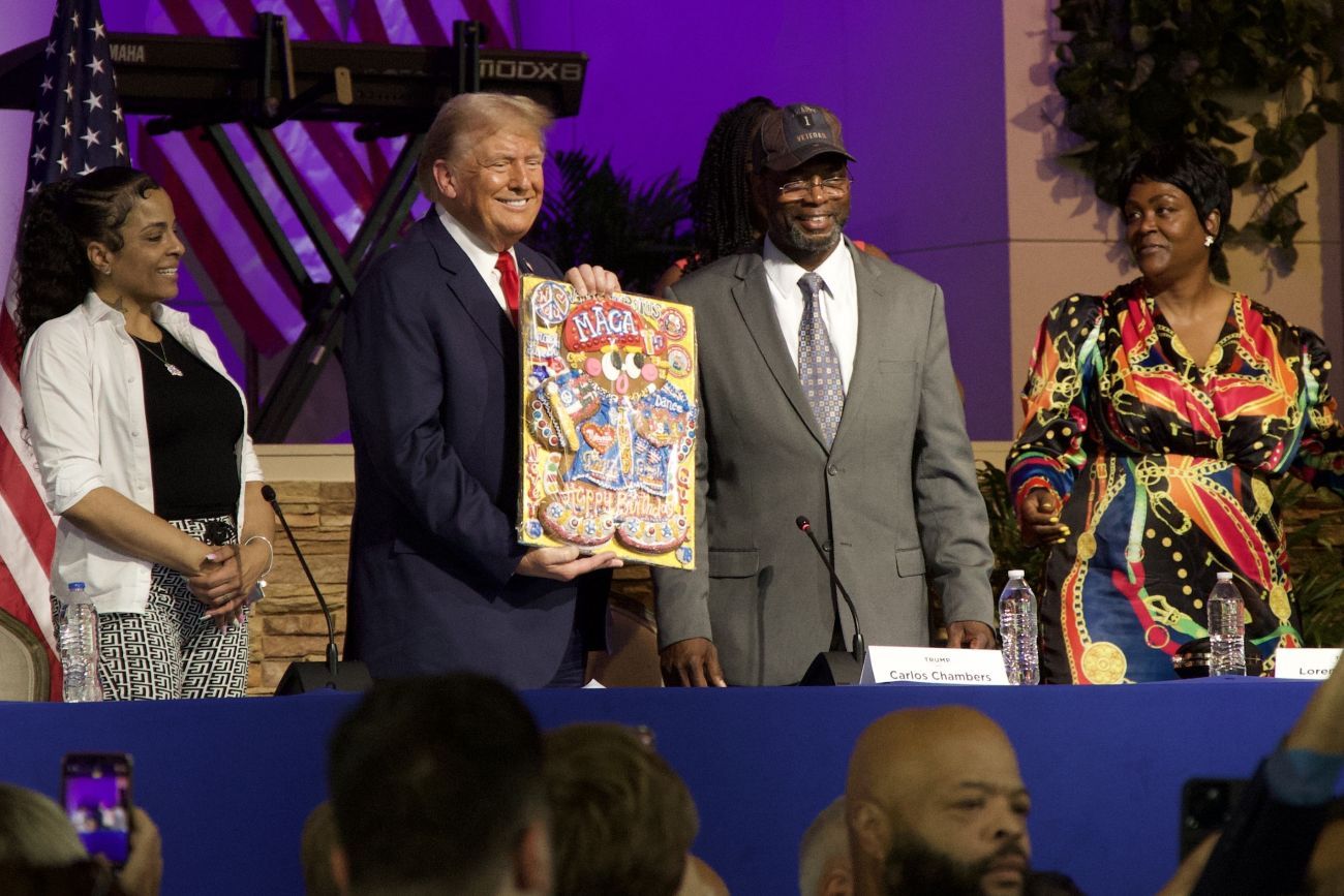 Donald Trump standing on stage in a Detroit church