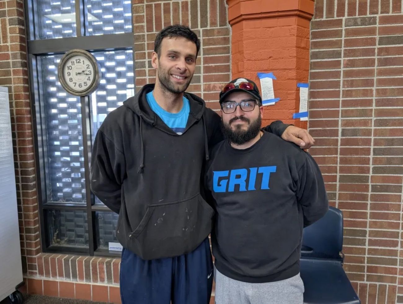 Zachary Benevides (left) and his friend, Beto Gallegos posing for a picture in a hallway