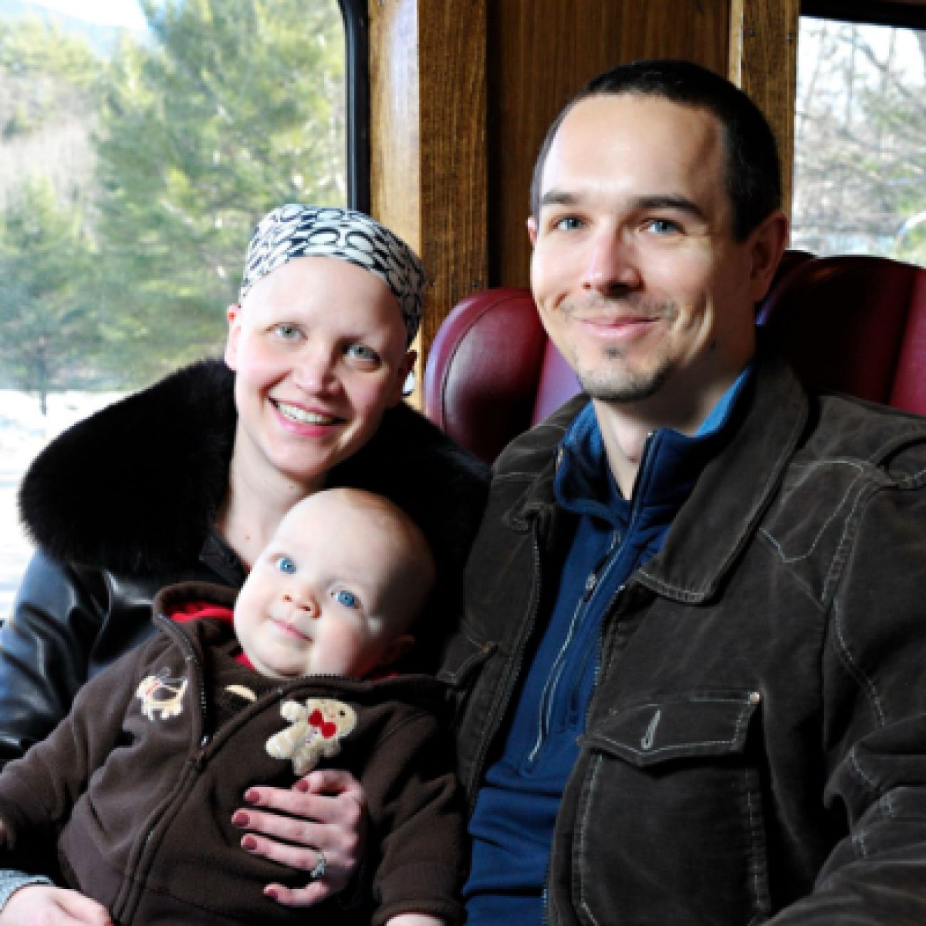 Woman and man sit together with a baby