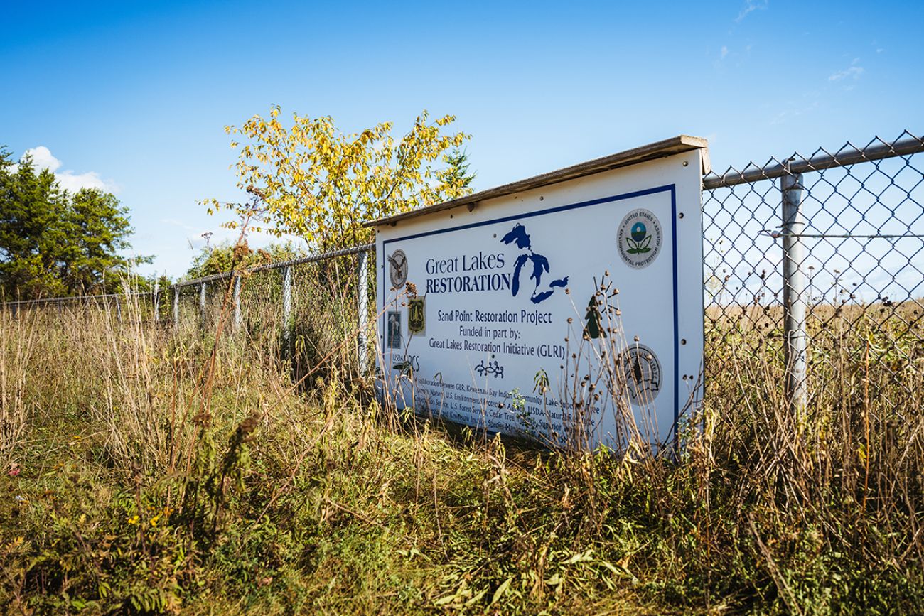 A sign on a fence for the Great Lakes Restoration 