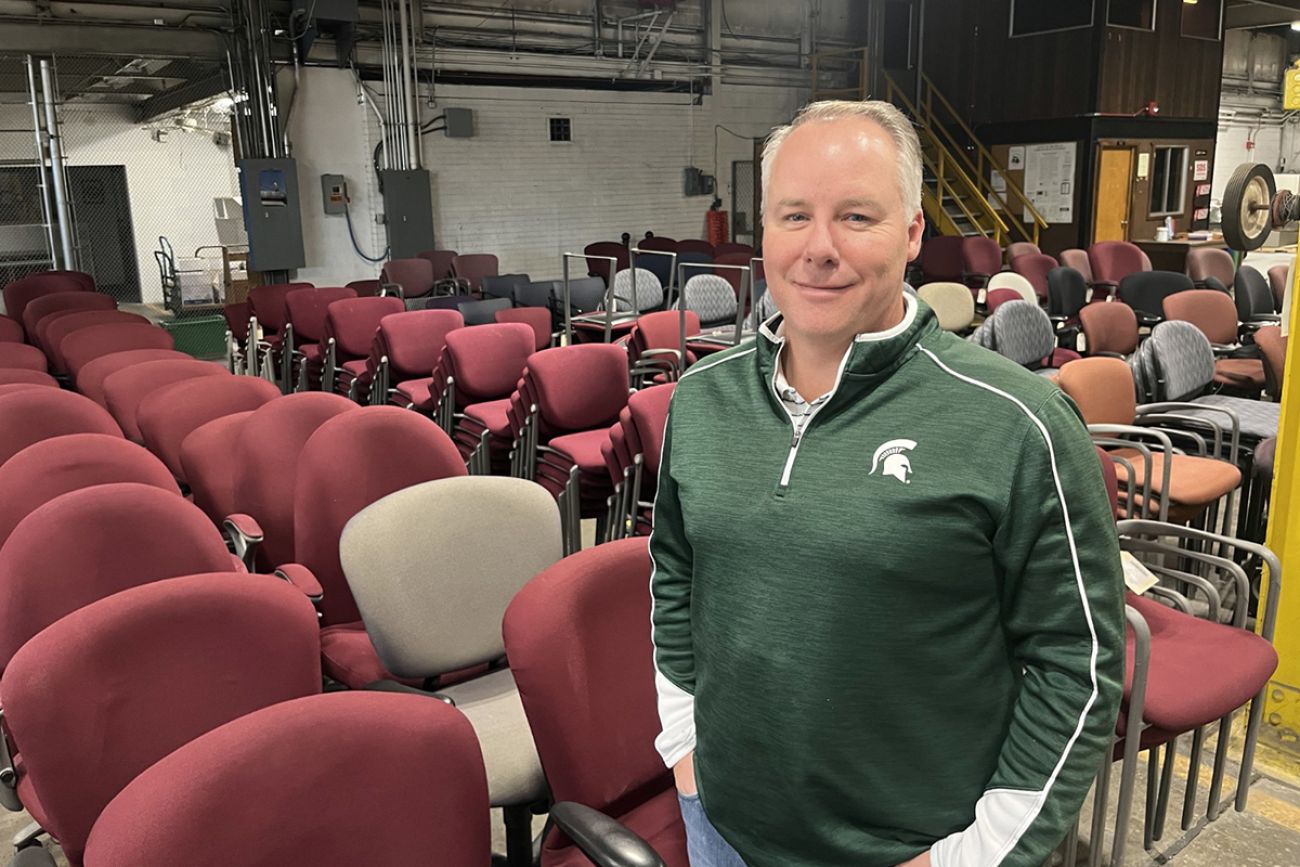 Ron Turner standing next to chairs