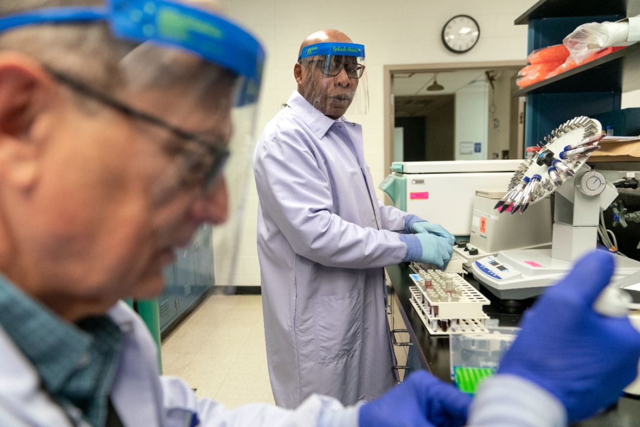 Two men stand in a lab