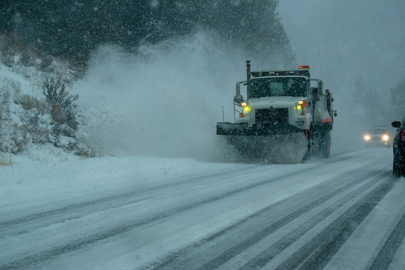 Snowplows work to clear snow off road