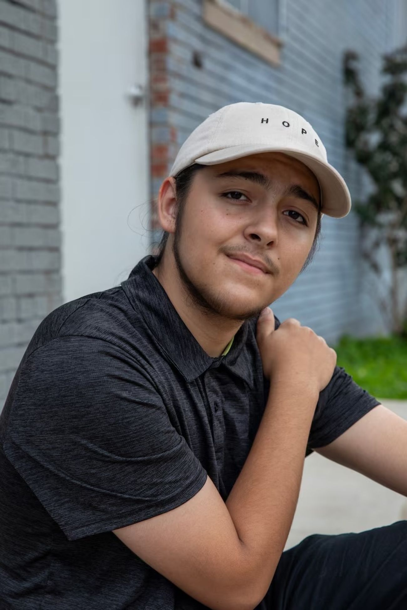 Lucian O’Donnell is wearing a baseball hat and black clothing