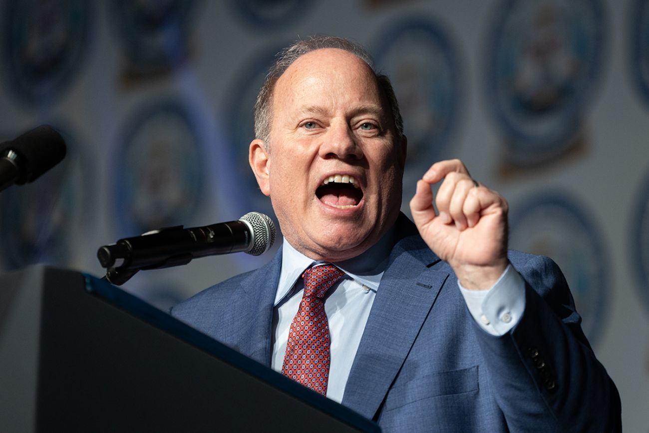 Detroit Mayor Mike Duggan is speaking into a microphone 