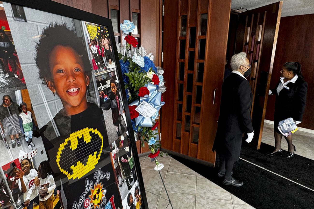 Pictures on display at the funeral for Darnell Currie Jr. and his sister A’millah Currie. In one photo, he is wearing a batman shirt.