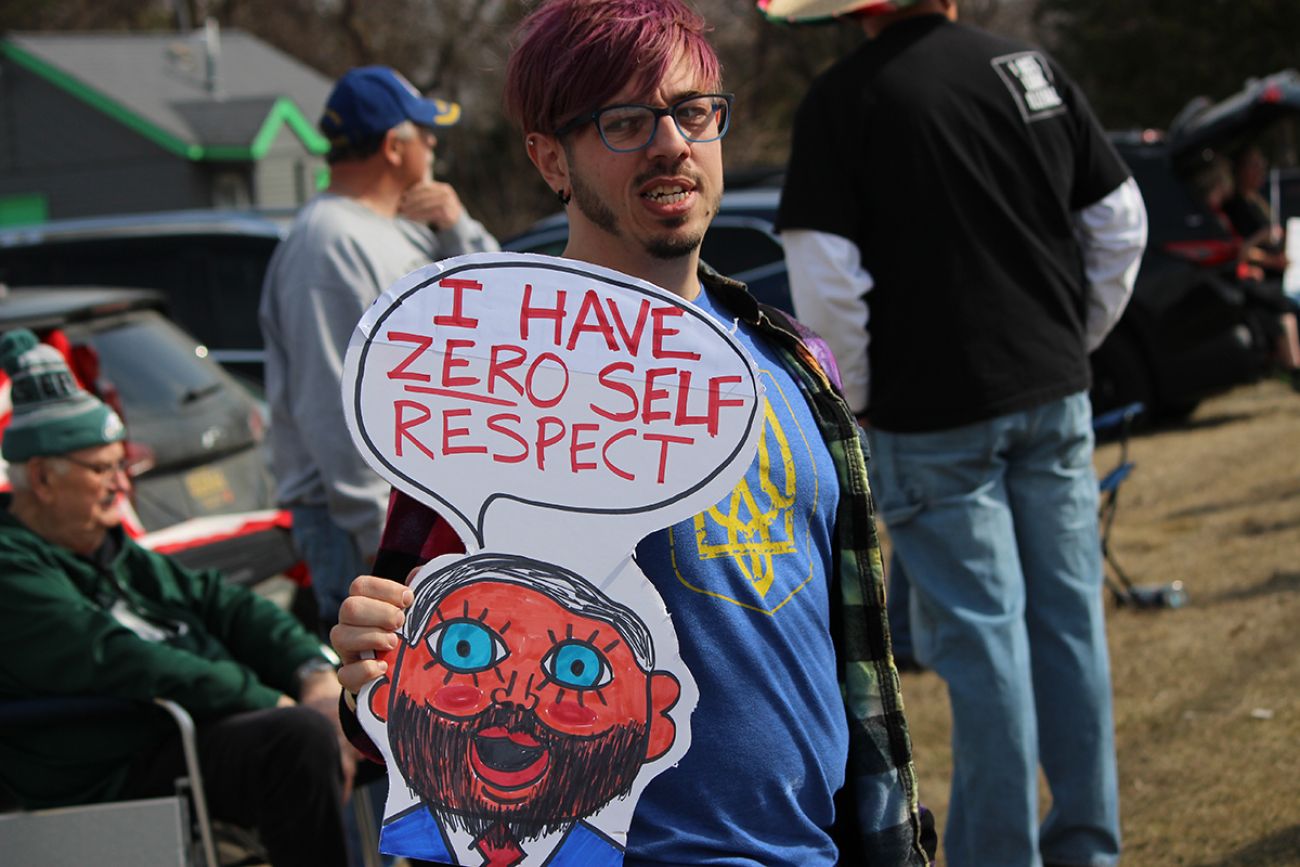 Colton Hughes holding a drawing of JD Vance. It says "I have zero self-respect." 