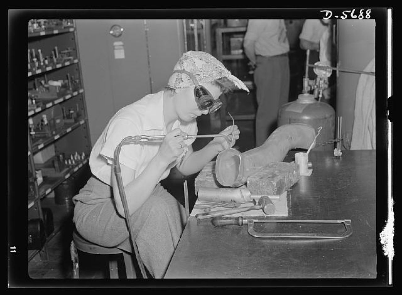 A historic photo of a woman welding. 