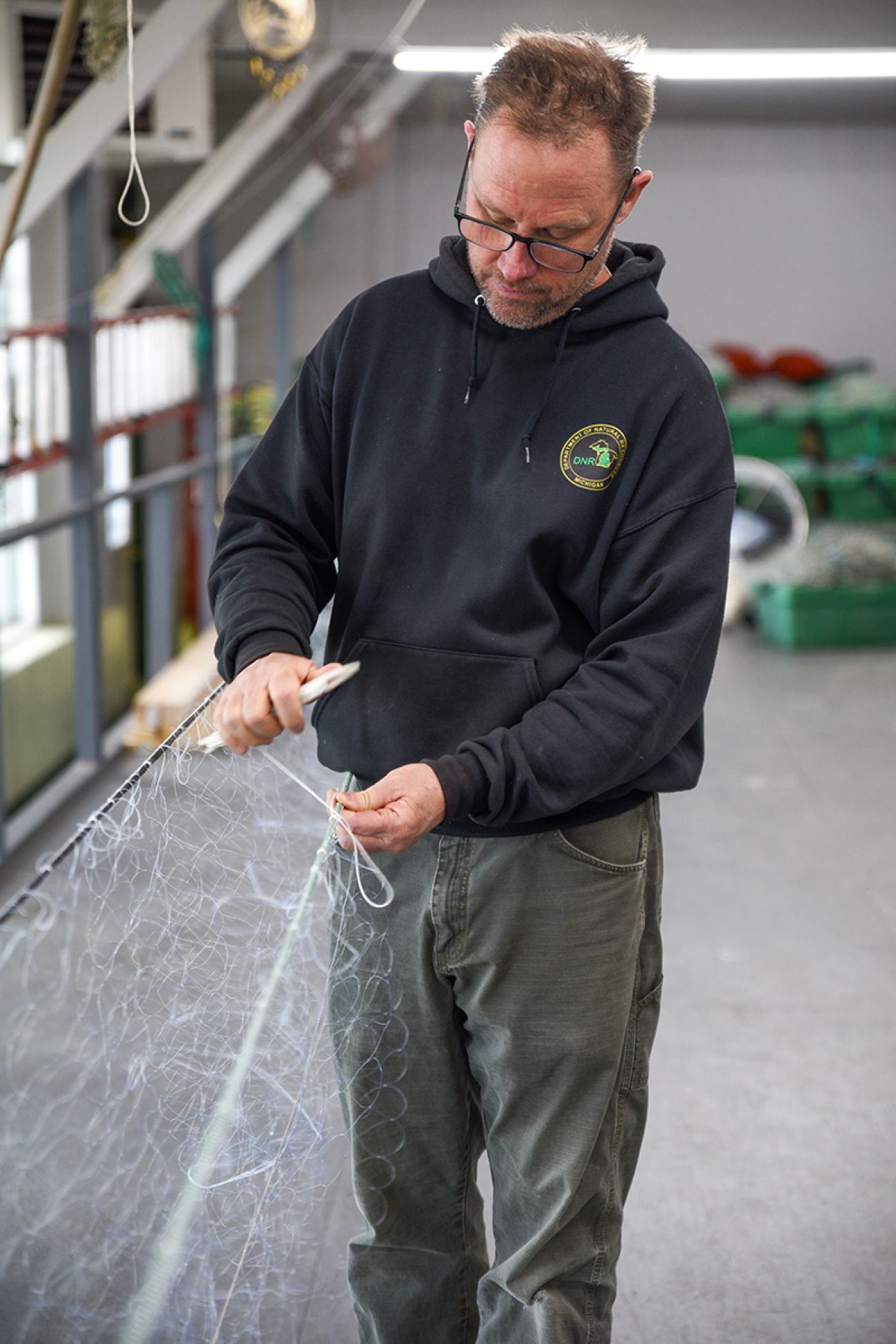Vessel Captain Patrick O’Neill looks at a net.