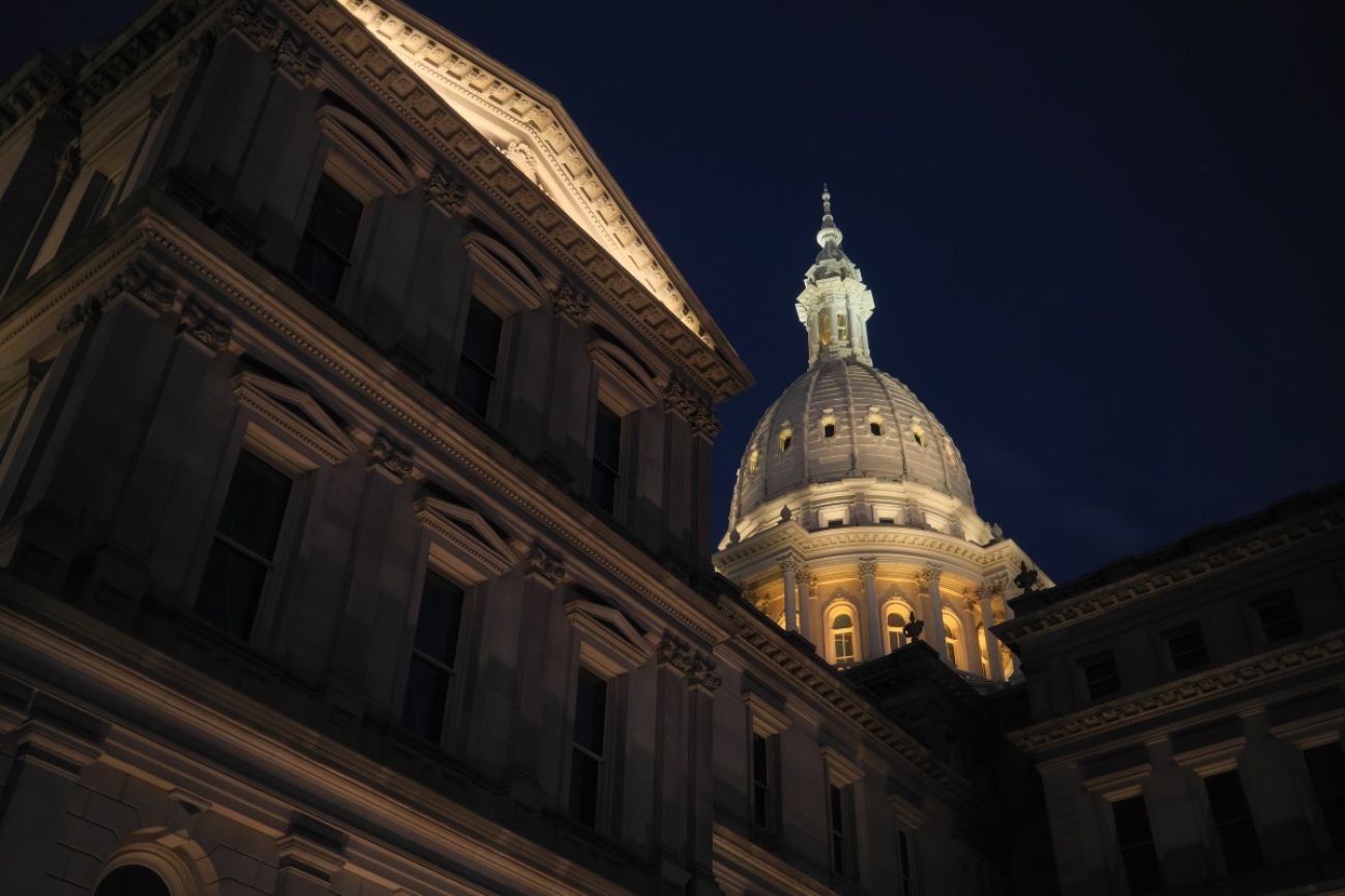 The Michigan Capitol dome is seen illuminated at night in downtown Lansing