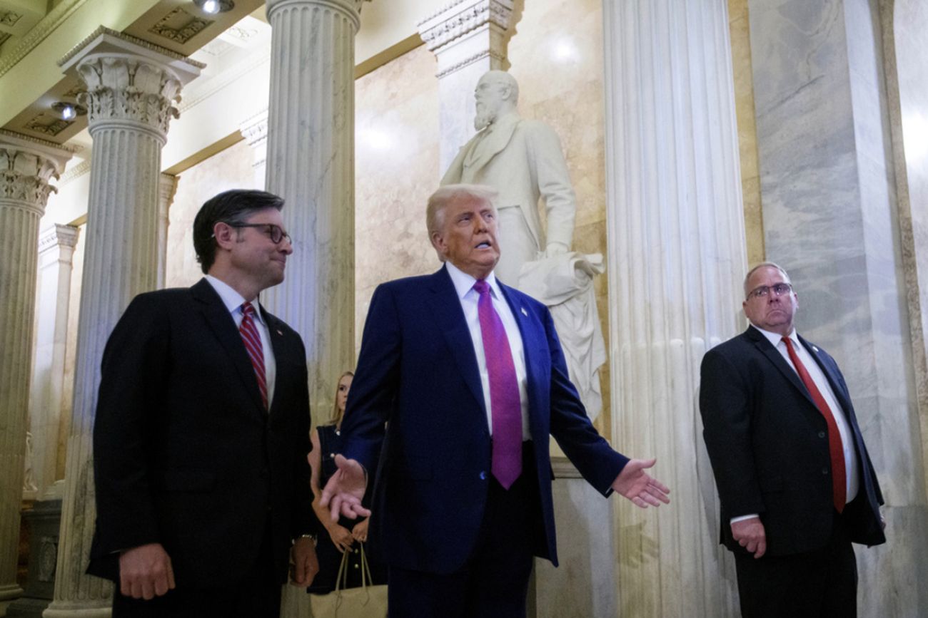 President Donald Trump stands next to Speaker of the House Mike Johnson.