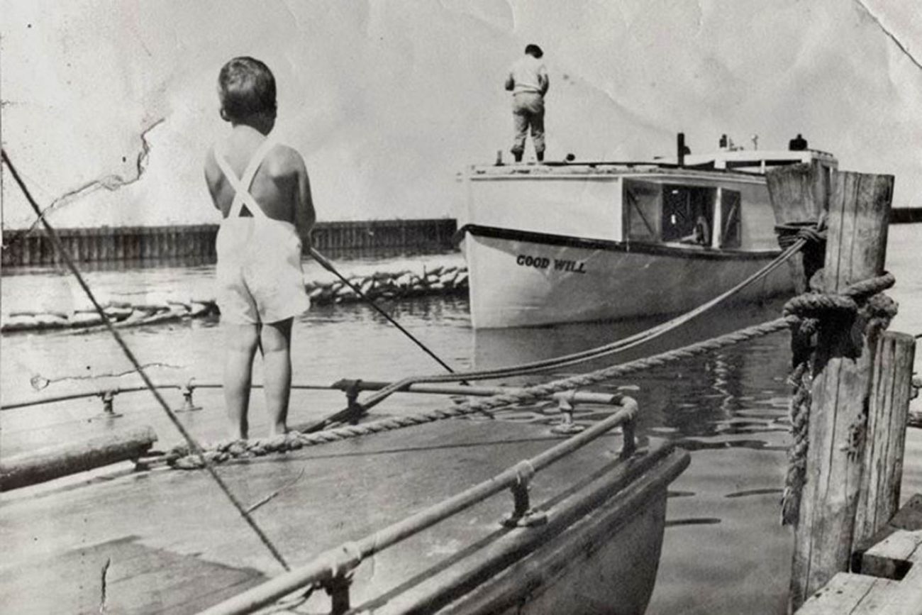 A historical photo of two boys fishing. 