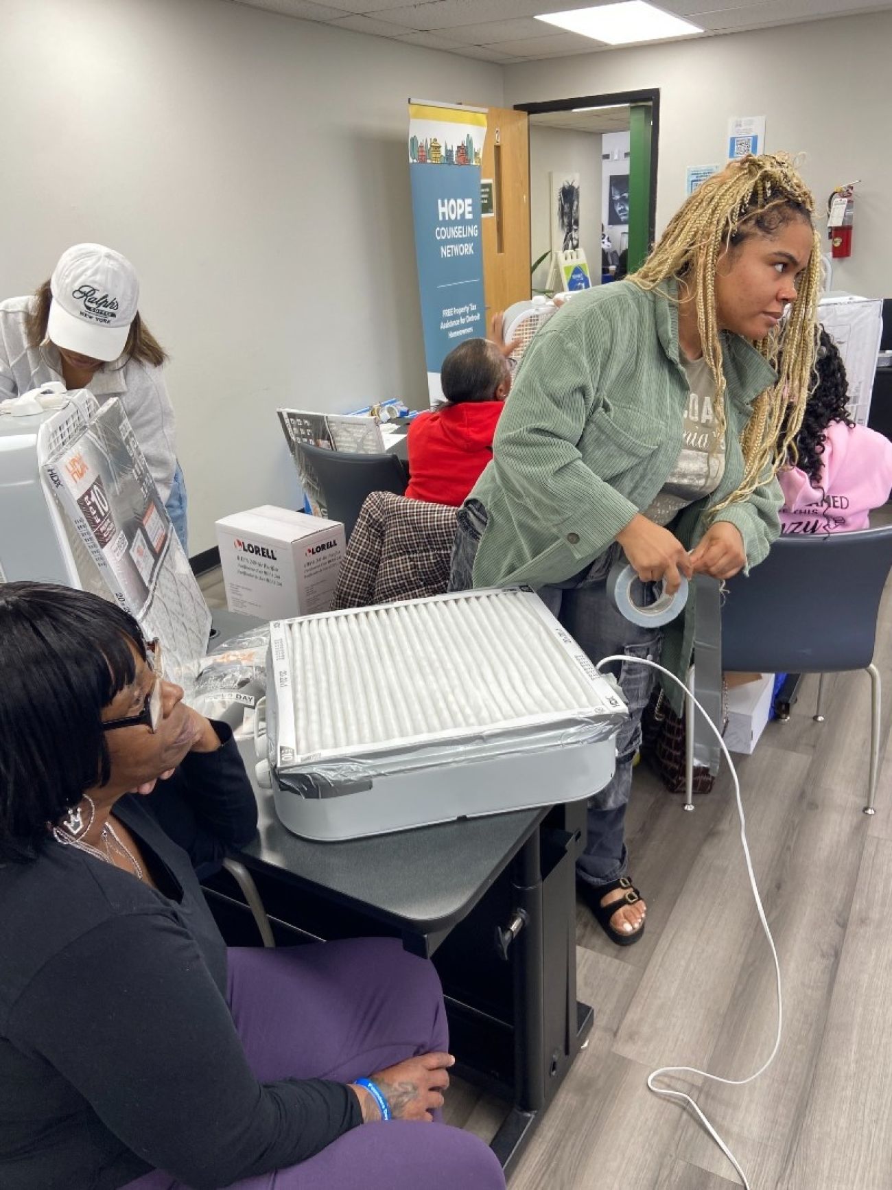 People gather around an air purifier