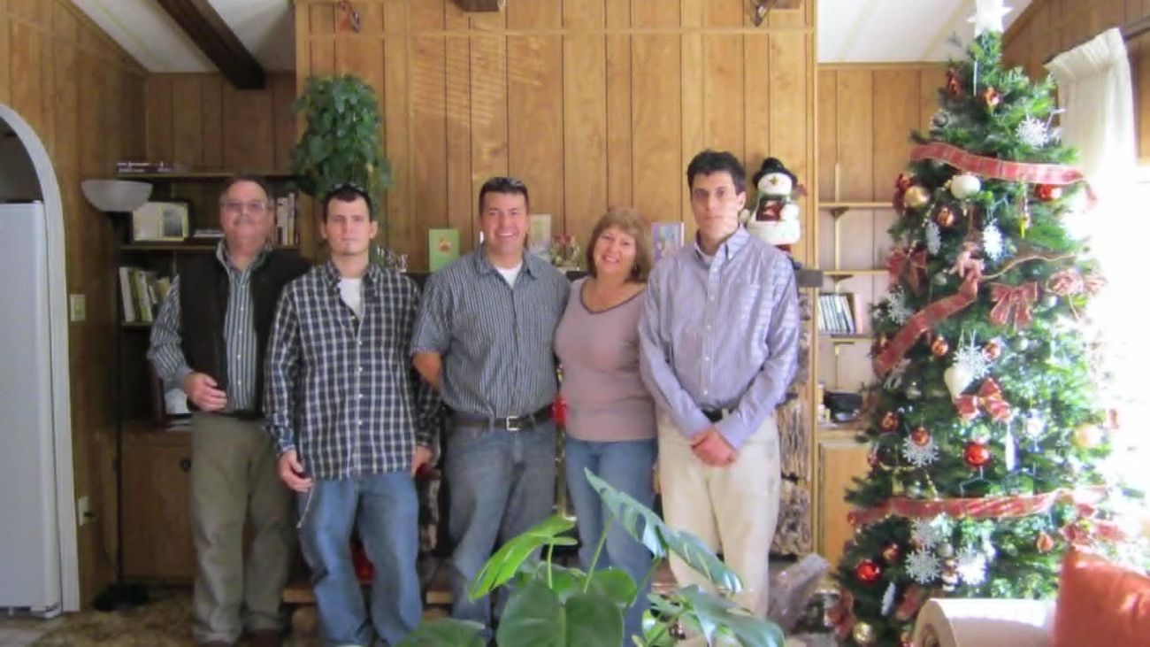 The Gille family poses for a picture in a living room around Christmas time. 