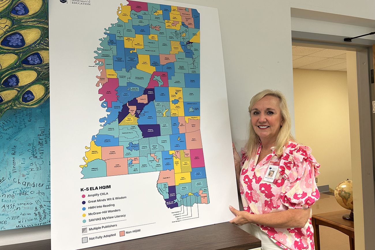 Michelle Nowell stands by a map.