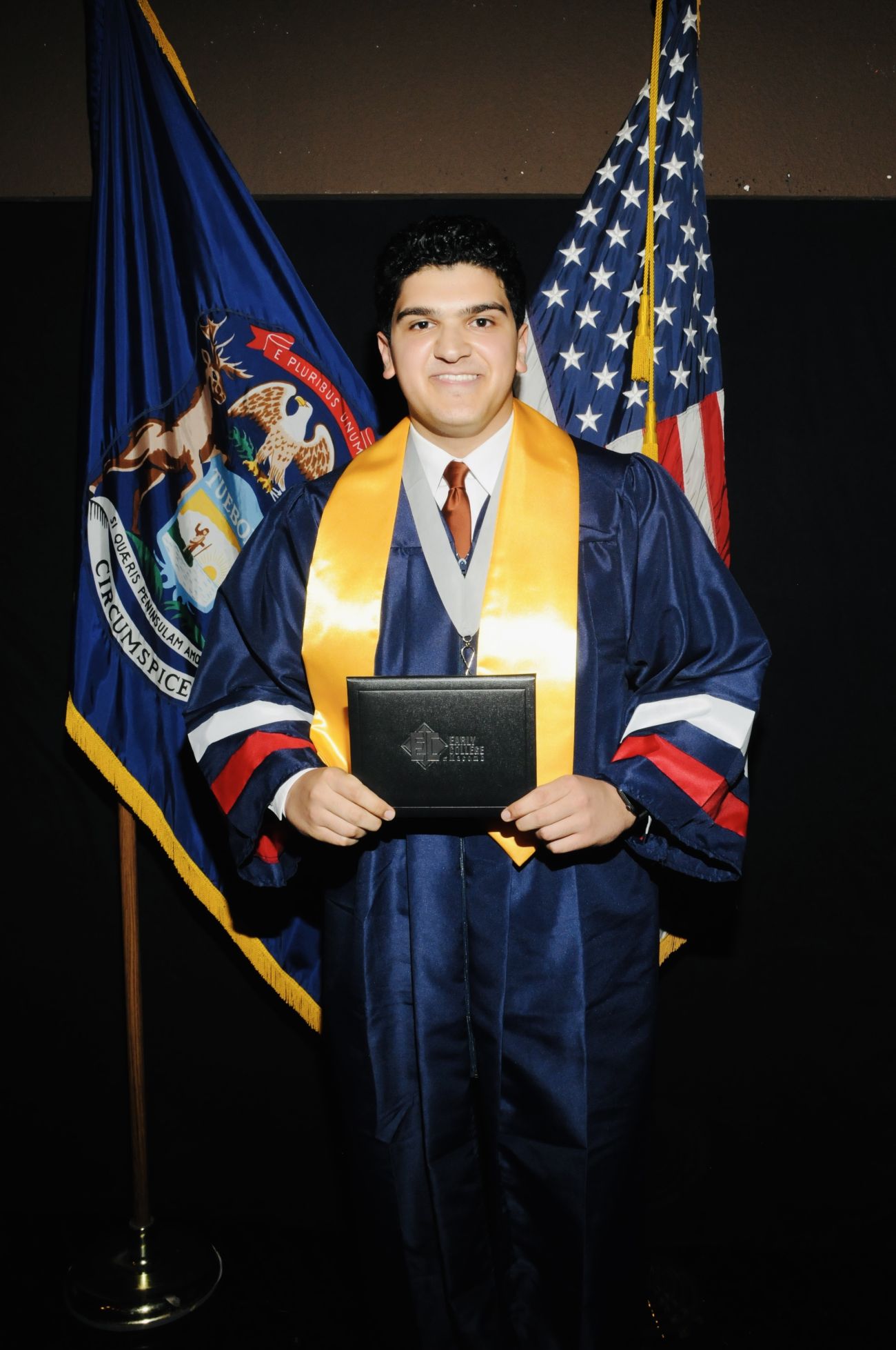 Abdullah Aljanabi holds up his diploma. 